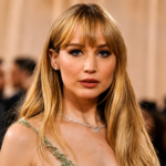 Jennifer Lawrence wearing an elegant gown at a red carpet event