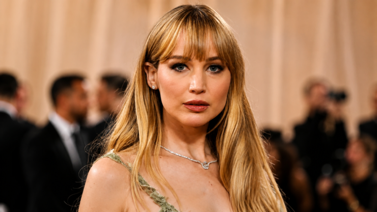 Jennifer Lawrence wearing an elegant gown at a red carpet event