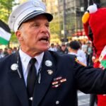 Firefighter confronting a pro-Palestinian protester near Ground Zero during a 9/11 anniversary