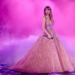 Taylor Swift performing in a pink gown during the Eras Tour