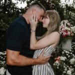 Couple sharing a romantic moment in a flower-filled garden