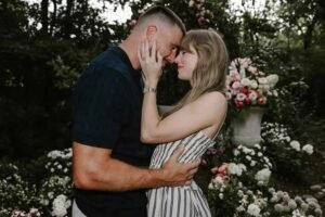 Couple sharing a romantic moment in a flower-filled garden